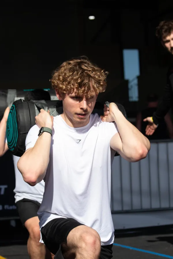 Kieran performing weighted sandbag lunges at KG FITNESS, Norwich