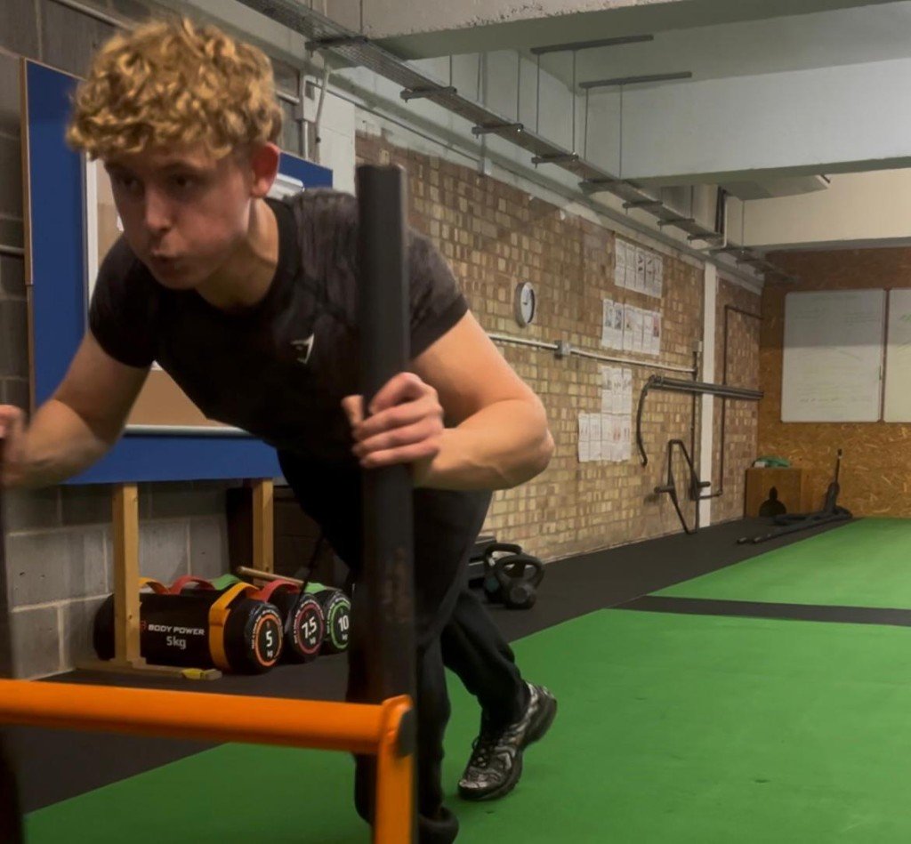 Kieran coaching a sled push at KG FITNESS, Norwich